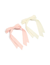Discover a 2-pack of fabric bow clips with scalloped edges in solid light pink and ivory front view - link has visual effect only