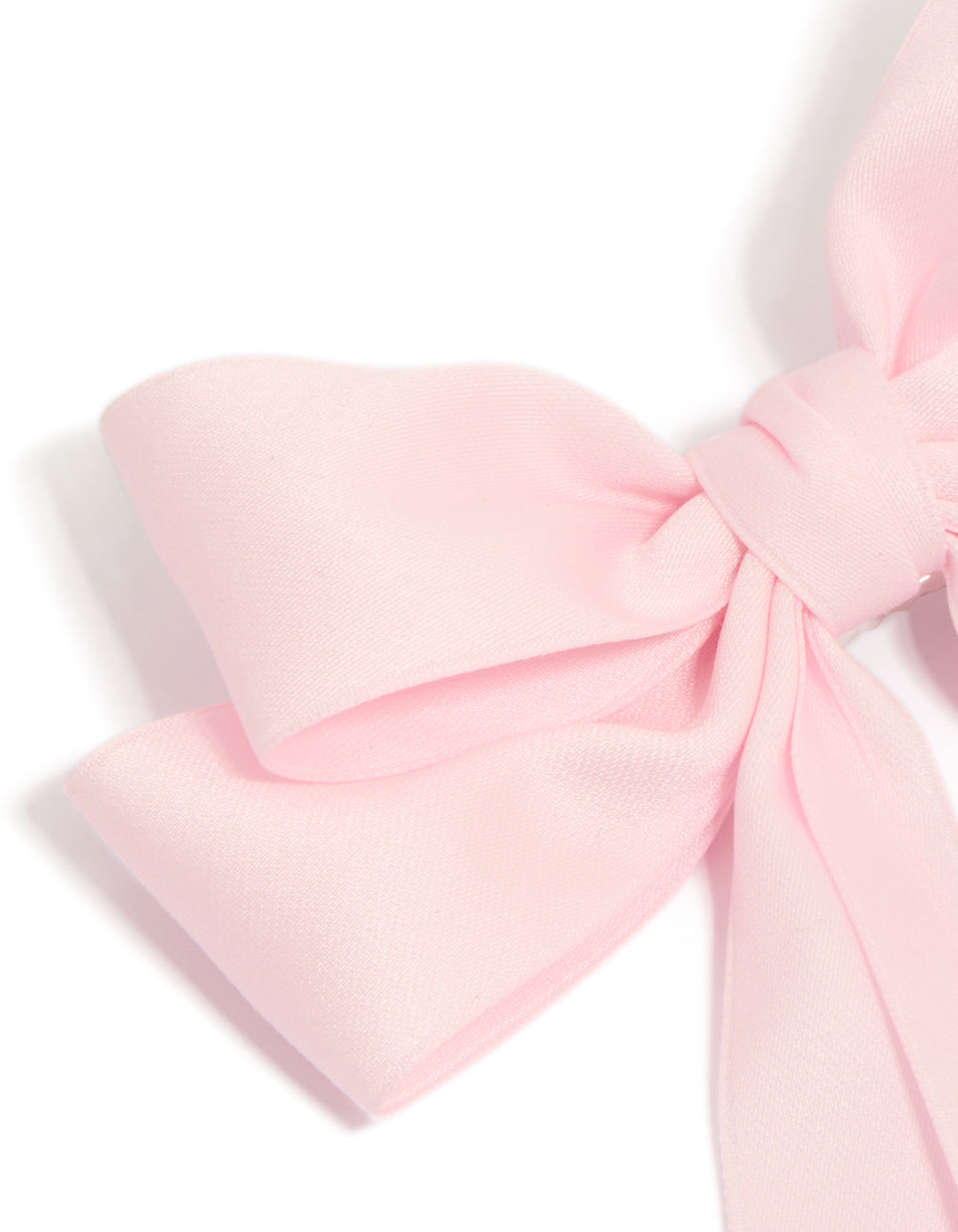 Designed with a bow in solid print featuring light pink statement hair clip side view