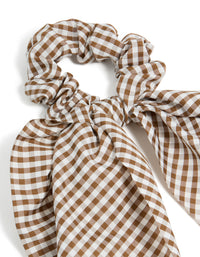 Featuring a checkered fabric scrunchie scarf in saddle brown and white side view - link has visual effect only