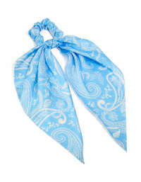 Showcasing a light blue paisley printed fabric scarf scrunchie featuring leaf details in white front view - link has visual effect only