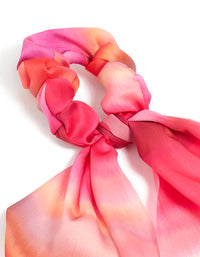 Showcasing a tie-dye long strap scarf scrunchie in statement hot pink, coral, and peachpuff shades detail view - link has visual effect only