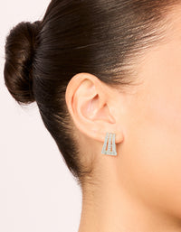 Featuring trio layered huggie earrings with cubic zirconia in silver plated finish on ear view - link has visual effect only