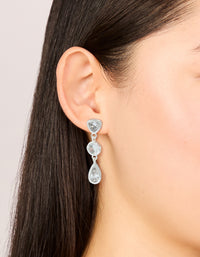 Featuring silver plated cubic zirconia organic circles triple drop earrings on ear view - link has visual effect only