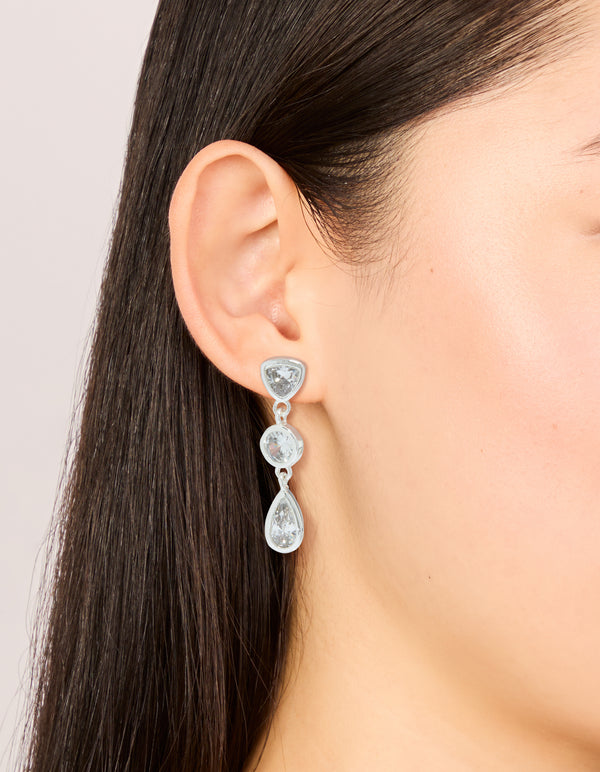 Featuring silver plated cubic zirconia organic circles triple drop earrings on ear view