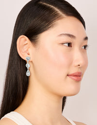 Displaying silver plated cubic zirconia organic circles triple drop earrings on model view - link has visual effect only