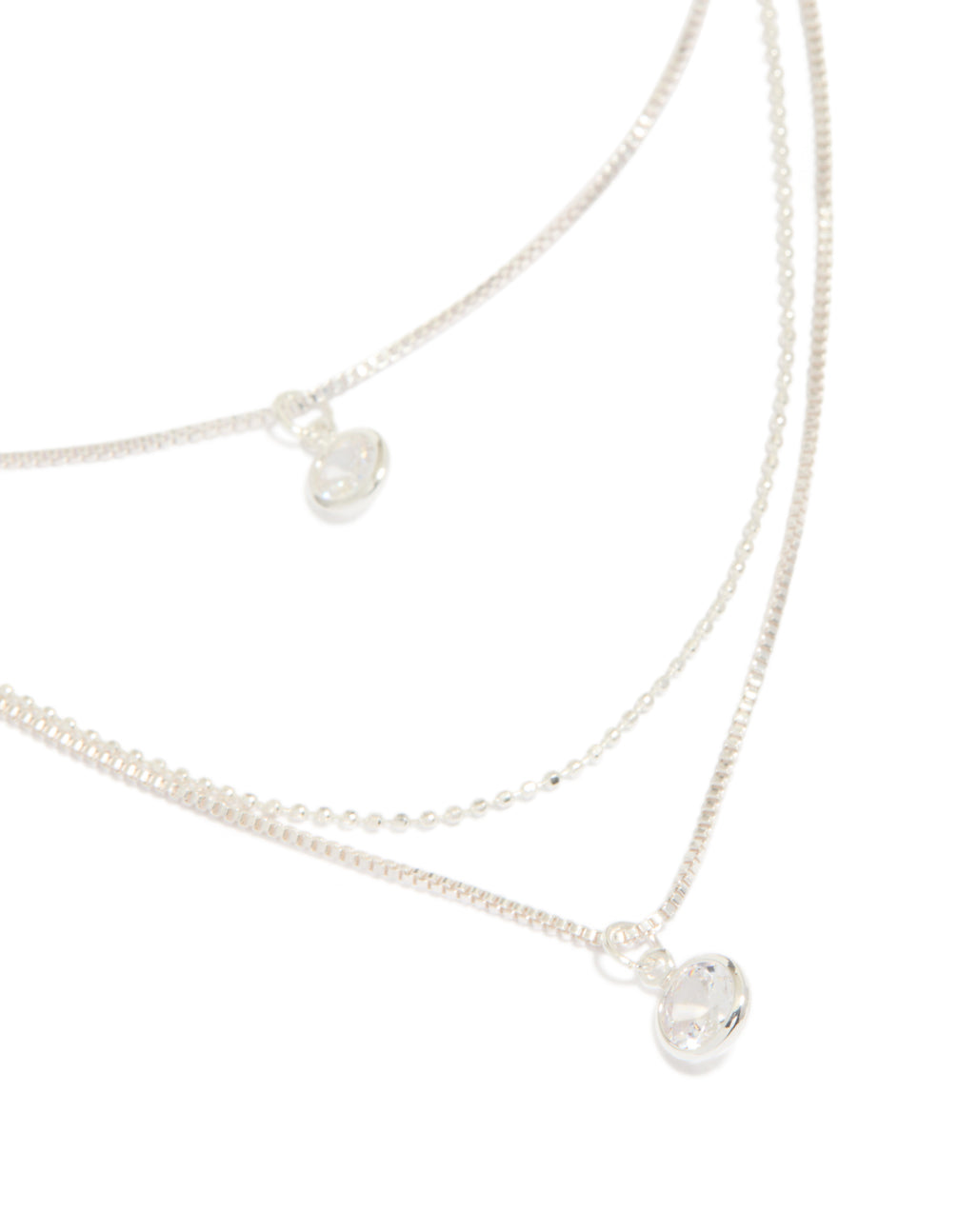 Showcasing a triple-layered drop necklace with beads, round-cut cubic zirconia, crafted from silver-plated material in a silver color close up view