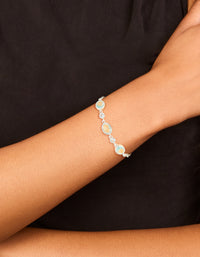 Featuring a silver plated blue cubic zirconia large bezel trio toggle bracelet with statement design on wrist view - link has visual effect only