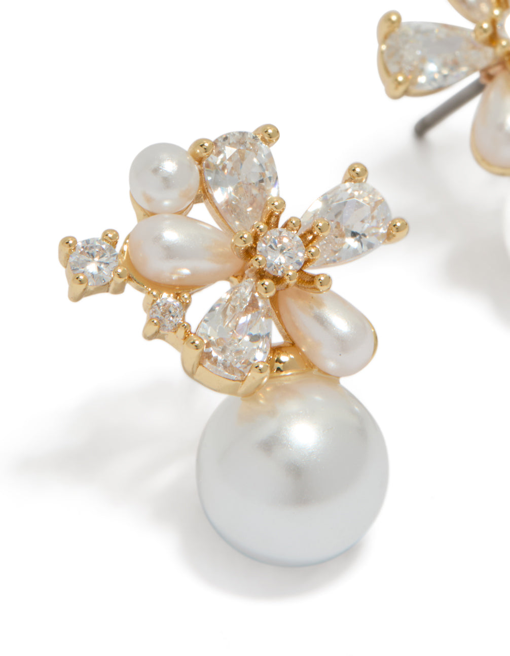 Crafted from gold plated material, these cubic zirconia flower pearl drop stud earrings feature white and ivory tones close up view