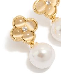 Showcasing gold plated pearl and flower drop earrings with floral detailing in white and ivory close up view - link has visual effect only