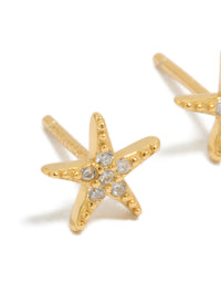 Featuring gold plated sterling silver cubic zirconia starfish earrings with ocean motifs in clear close up view - link has visual effect only