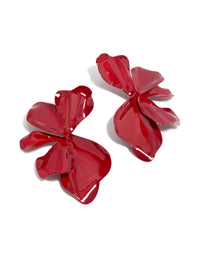 Showcasing large statement stud earrings with floral petal design in red coated metal front view - link has visual effect only