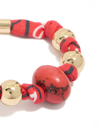 Crafted with beads accents in gold and red, this wrapped bracelet with stones close up view - link has visual effect only