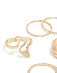 Featuring gold dainty organic rings in a 7-pack close up view - link has visual effect only