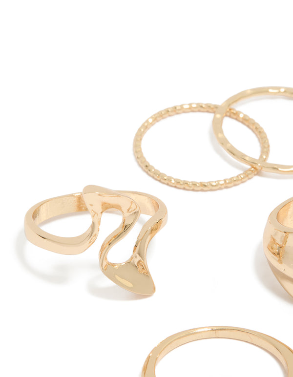 Featuring gold dainty organic rings in a 7-pack close up view