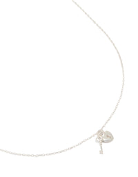 Discover a heart and key pendant necklace featuring charm detailing crafted from sterling silver in a beautiful silver color close up view - link has visual effect only