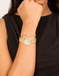 Stylish gold watch and flower bracelet, white dial, roman numerals, round shape, formal occasion design, link band, and analog type on wrist view - link has visual effect only