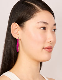 Stylish hot pink threaded hoop earrings featuring statement design with gold accents on model view - link has visual effect only