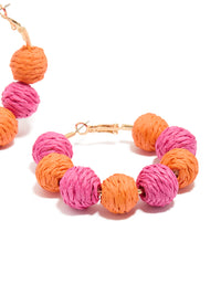 Designed with paper balls in hot pink, coral and gold, these statement hoop earrings offer post detail view - link has visual effect only