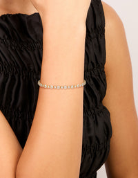 Featuring a gold plated large square cut cubic zirconia tennis bracelet on wrist view - link has visual effect only