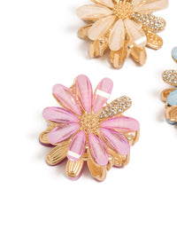 Showcasing glitter floral print 3-pack gold pastel daisy claw clips in pink, powder blue, and peachpuff detail view - link has visual effect only