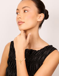 Stylish gold plated pearl and cubic zirconia bracelet featuring celestial star and moon charm styled on model view - link has visual effect only