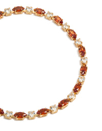 Highlighting a gold plated tennis bracelet featuring clear and cognac cubic zirconia in multi cut close up view - link has visual effect only
