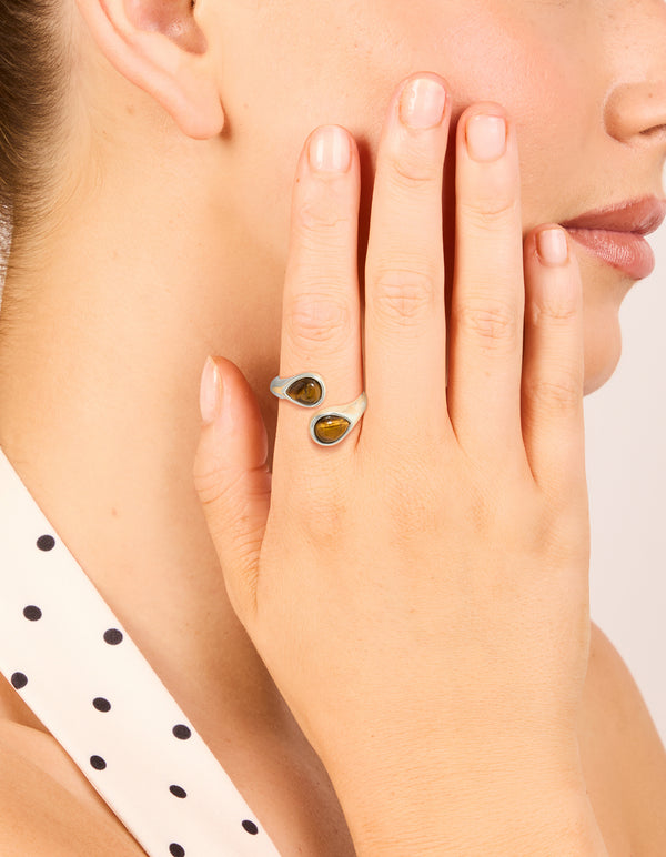 Featuring a waterproof stainless steel ring with double tigers eye stones in silver and brown tones on finger view