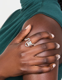 Featuring a waterproof stainless steel wavy cubic zirconia statement ring with crystal in silver and clear on finger view - link has visual effect only
