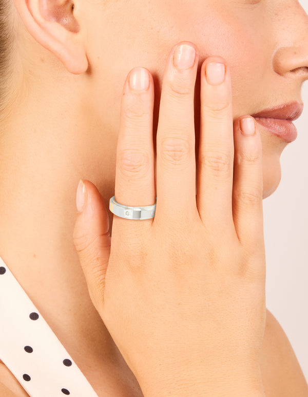 Crafted from waterproof cubic zirconia stainless steel, this spinner ring in silver and clear stone on finger view