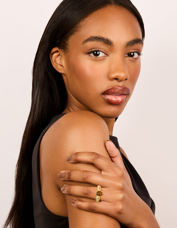 Presenting gold plated cubic zirconia clear and brown puffy rings in a 2-pack with dainty styling on finger view