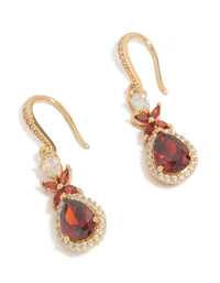 Showcasing statement drop earrings crafted from cubic zirconia with dark red teardrop stones surrounded by clear crystals in a gold setting, front view - link has visual effect only