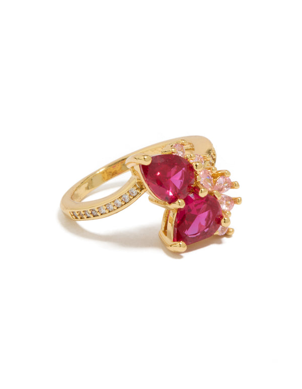 Showcasing a gold plated statement ring with double pear cut red and light pink cubic zirconia side detail view