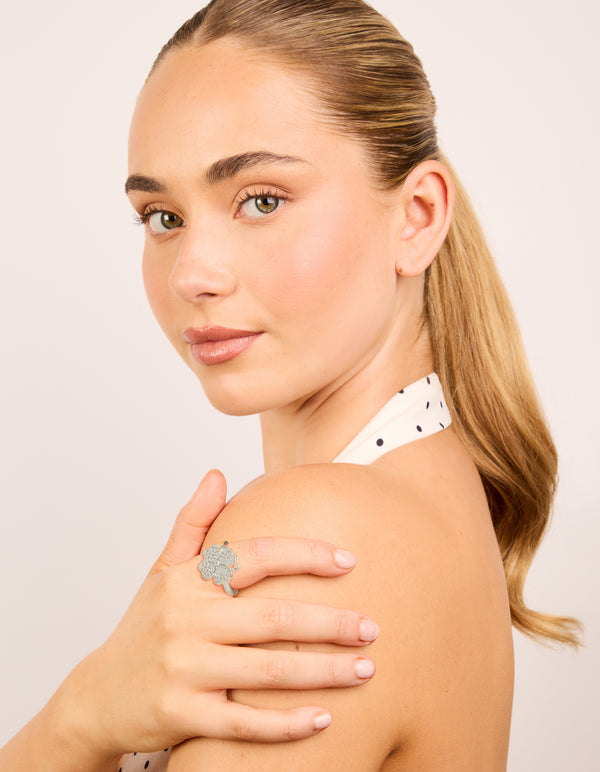 Designed with waterproof stainless steel, this spinning clover ring showcases floral, heart and cubic zirconia in silver and clear on model view
