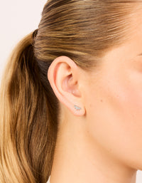 Showcasing waterproof stainless steel cubic zirconia marquise fan flat back studs with gold plated finish in silver and clear on ear view - link has visual effect only