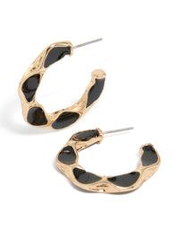 Showcasing textured hoop earrings with enamel in gold and black front view - link has visual effect only
