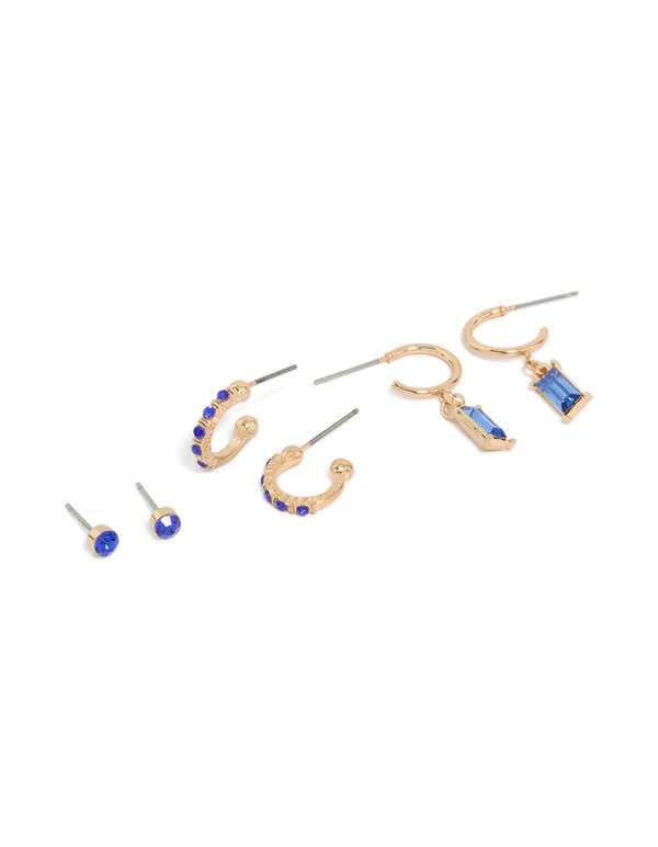 Featuring dark blue diamante studs and drop earrings in a 3-pack with baguette stone cut, huggie, hoop, and stud closures, crafted in gold front view
