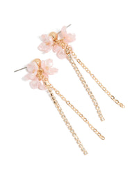 Showcasing statement drop earrings with pink floral charm, diamante embellished chain, and gold finish front view - link has visual effect only