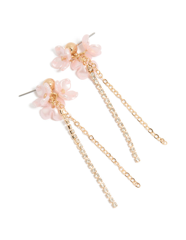 Showcasing statement drop earrings with pink floral charm, diamante embellished chain, and gold finish front view