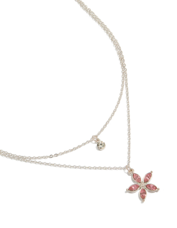 Showcasing a clear and pink diamante flower layered necklace in silver close up view