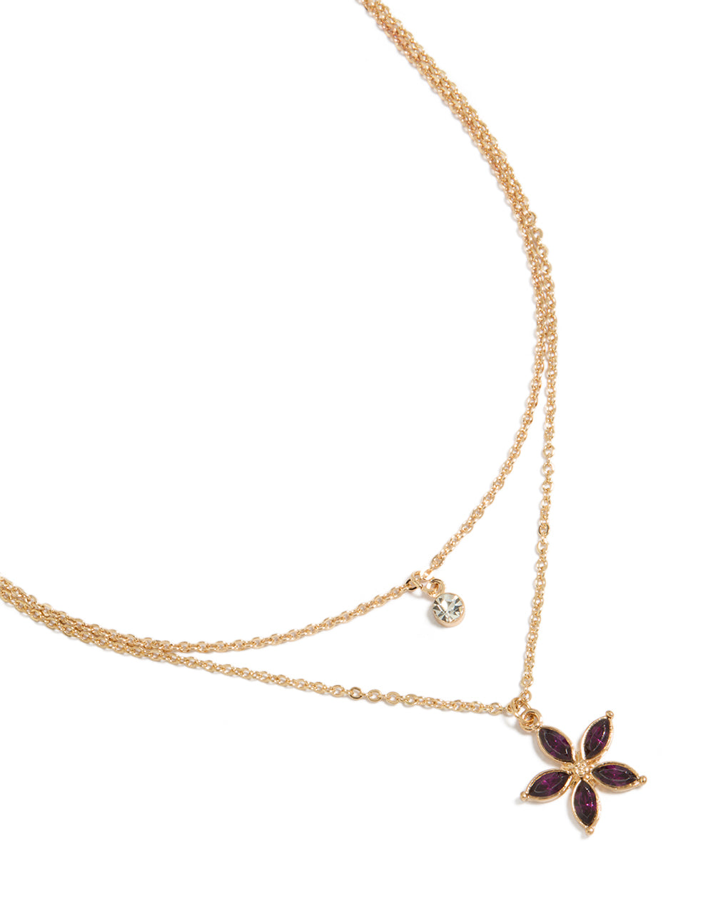 Showcasing a gold layered necklace with clear and purple diamante floral pendant close up view
