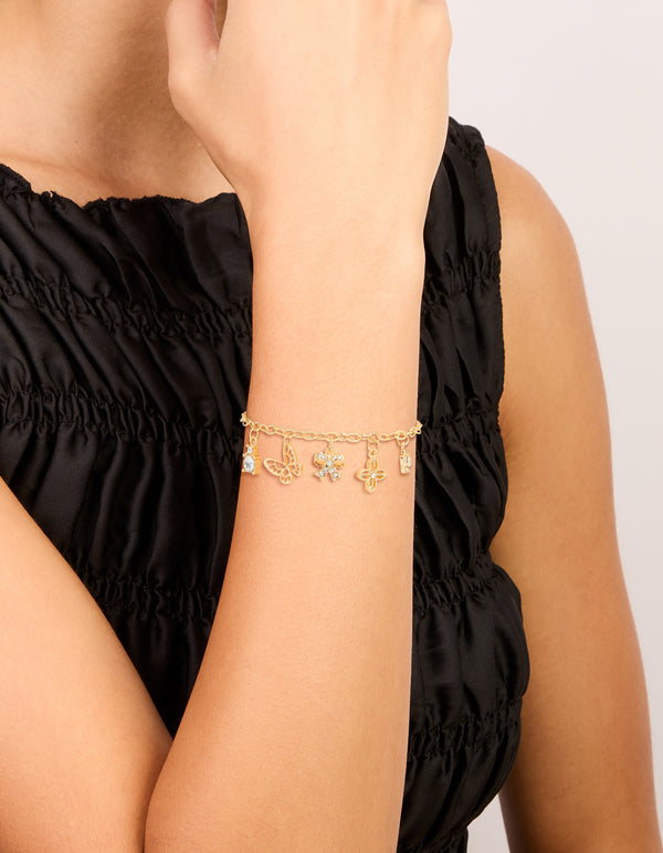 Showcasing a gold plated diamante butterfly bow charms toggle bracelet on wrist view