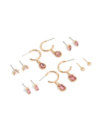 Showcasing a 7-pack of gold pink diamante stud and hoop earrings featuring baguette and oval stone cuts front view - link has visual effect only