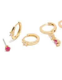 Showcasing dainty gold plated studs and huggie earrings 3-pack with dark pink cubic zirconia and crystal embellishments close up view - link has visual effect only