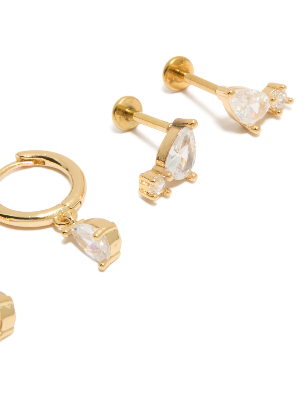 Highlighting teardrop cubic zirconia flat back studs and huggie earrings with gold plated titanium construction close up view