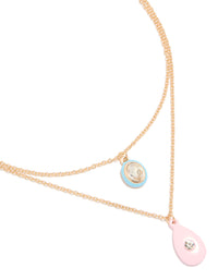 Showcasing a gold acrylic and diamante pendant layered necklace close up view - link has visual effect only