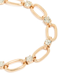 Featuring a gold oval chain bracelet with diamante details close up view - link has visual effect only