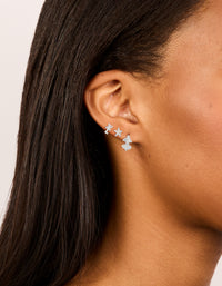 Crafted from silver with floral design Cubic Zirconia Flower Stud and Huggie Earrings 3-Pack on ear view - link has visual effect only