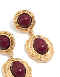 Detailed view of statement gold double burgundy resin drop earrings featuring maroon cabochons in textured settings post detail view - link has visual effect only