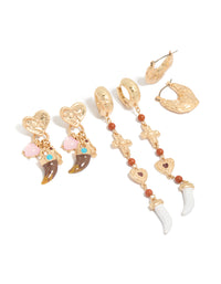 Stunning worn gold statement earrings 3-pack featuring beads, charm, cross, heart, and huggie and stud closure front view - link has visual effect only