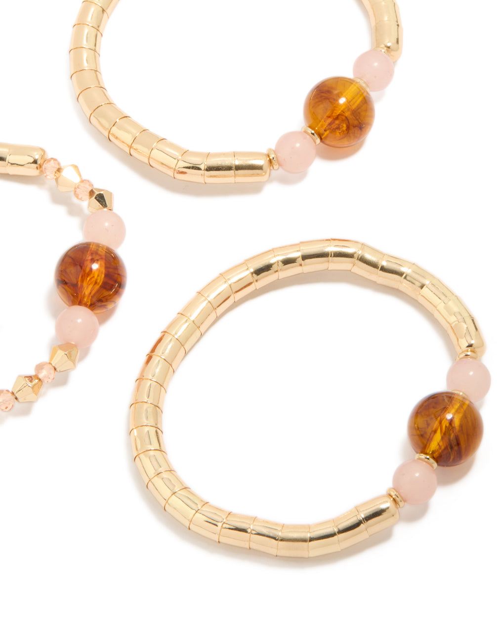 Showcasing beaded resin stretch bracelets in a 3-pack with gold and brown tones close up view